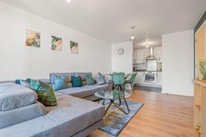 a living room with a couch and a table at Skyline Haven - Central B'ham Apt - Free Parking in Birmingham