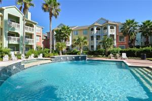 a swimming pool in front of some apartment buildings at 2 Bd, Oceanfront Oasis, Lots of deals and Winter Texans book early in Galveston
