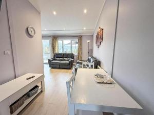 a living room with a white table and a couch at Cosy Chalet On A Beautiful Holiday Park In Lowestoft Ref 12080B in Lowestoft