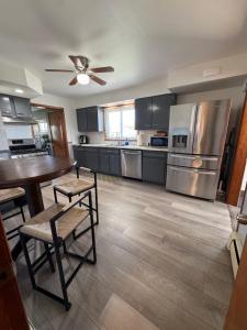 a kitchen with stainless steel appliances and a table and chairs at Luxury Villa in Lancaster
