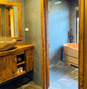 a bathroom with a tub and a sink at Chapa Ecolodge in Sapa