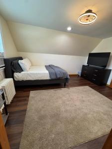 a bedroom with a bed and a tv and a rug at Luxury Villa in Lancaster