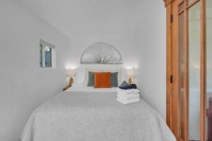 a bedroom with a large bed with two lamps at Near All Things SD - Canyonview - Jacuzzi - EV Charge in San Diego