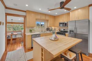 a kitchen with wooden cabinets and a wooden counter top at Near All Things SD - Canyonview - Jacuzzi - EV Charge in San Diego