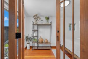 a hallway with a table with vases on it at Near All Things SD - Canyonview - Jacuzzi - EV Charge in San Diego +64 photos