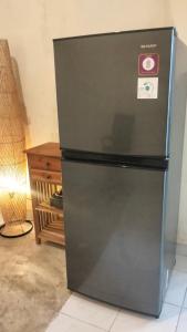 Un refrigerador negro con un reloj en el costado. en Rumah Sedana, en Ubud