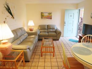 a living room with a couch and a table at Sand Dollar Beach Side Villa in Holmes Beach