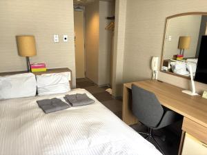 Postel nebo postele na pokoji v ubytování Hotel Tetora Spirit Sapporo