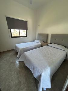 a bedroom with two beds and a window at Apolo Apartment, near the beach with pool in Barra de Navidad +38 photos