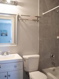 a bathroom with a toilet and a sink and a shower at 5Guest House Baltimore County(own room, Joppa RD) in Parkville