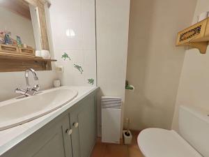 a white bathroom with a sink and a toilet at Studio mezzanine charmant, 3 couchages, proche plage - FR-1-224B-245 in Barbâtre