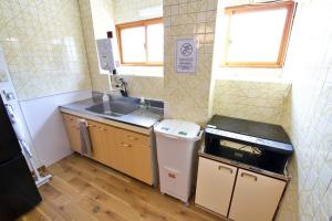 a small kitchen with a sink and a dishwasher at okn飛騨高山201 in Takayama +58 photos