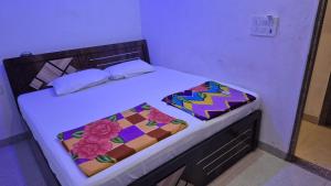 a bedroom with a bed with a colorful quilt on it at Baba Shyam hotel in Rīngas