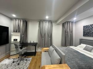 a bedroom with a bed and a desk at The Gray Loft Escape NYC Edition. in New York