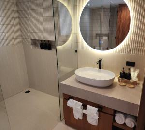 a bathroom with a sink and a mirror at Baan Bophut Beach Hotel Samui - SHA Extra Plus in Bophut