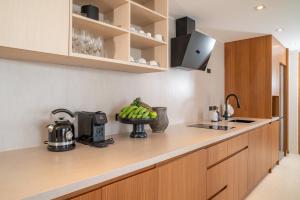 a kitchen with a bowl of fruit on a counter at Baan Bophut Beach Hotel Samui - SHA Extra Plus in Bophut