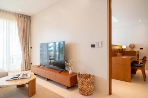 a living room with a flat screen tv on a wall at Baan Bophut Beach Hotel Samui - SHA Extra Plus in Bophut