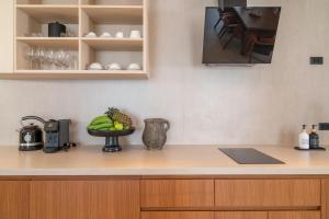 a kitchen with a bowl of fruit on a counter at Baan Bophut Beach Hotel Samui - SHA Extra Plus in Bophut