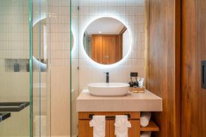 a bathroom with a sink and a mirror at Baan Bophut Beach Hotel Samui - SHA Extra Plus in Bophut