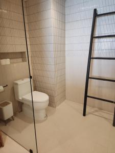 a bathroom with a toilet and a ladder in it at Baan Bophut Beach Hotel Samui - SHA Extra Plus in Bophut
