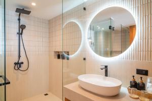 a bathroom with a sink and a mirror at Baan Bophut Beach Hotel Samui - SHA Extra Plus in Bophut