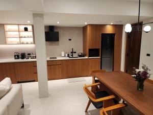 a kitchen and living room with a table and a couch at Baan Bophut Beach Hotel Samui - SHA Extra Plus in Bophut