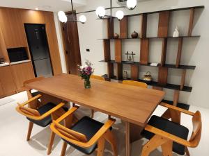 a dining room with a wooden table and chairs at Baan Bophut Beach Hotel Samui - SHA Extra Plus in Bophut