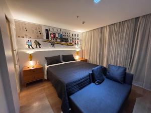 a bedroom with a bed and a couch in it at Itaim Bibi Flat com varanda in Sao Paulo +103 photos