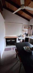 a kitchen with a table and chairs in a room at La Posada del Mainumby in Ituzaingó +8 photos