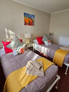 a room with two beds and a couch in it at On Tate in Waitara