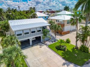 an aerial view of a house with palm trees at The Austin Pearl in Fort Myers Beach