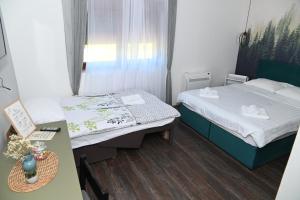 Postel nebo postele na pokoji v ubytování Apartmani Drijen