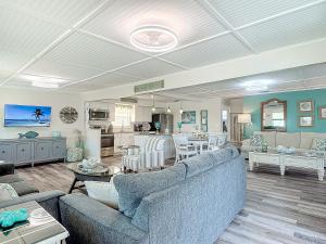 a living room with two couches and a kitchen at The Austin Pearl in Fort Myers Beach