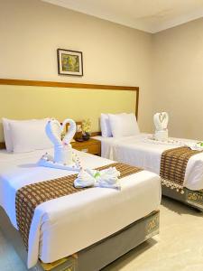 Ένα ή περισσότερα κρεβάτια σε δωμάτιο στο Sultan Hotel Banda Aceh