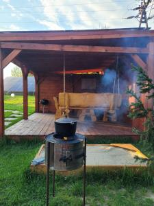 a grill with a pot on top of a deck at Apartement u Jędrusia w ogrodzie in Żywiec