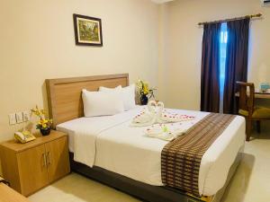 Ένα ή περισσότερα κρεβάτια σε δωμάτιο στο Sultan Hotel Banda Aceh