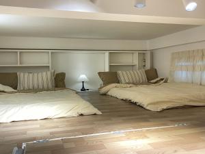 a room with two beds and a couch in it at Homestay Nha Trang in Nha Trang