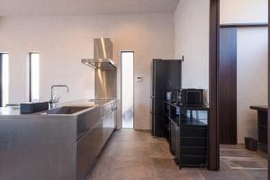 a kitchen with a sink and a refrigerator at Gold Valley Villa A in Futtsu +47 photos