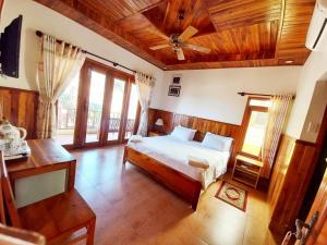 a bedroom with a bed and a ceiling fan at Free Beach Resort in Phú Quốc