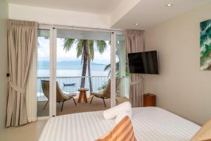 a bedroom with a bed and a view of the ocean at Baan Bophut Beach Hotel Samui - SHA Extra Plus in Bophut  +113 photos