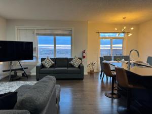 a living room with a couch and a table at Exquisite Entire 4- Bed rooms vacation home! in Calgary