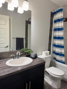 a bathroom with a sink and a toilet at Exquisite Entire 4- Bed rooms vacation home! in Calgary +34 photos