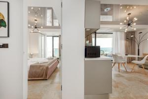 a bedroom and a living room with a bed and a table at Astria Siena - Complex Novum in Olimp
