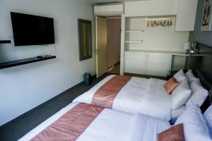 Postel nebo postele na pokoji v ubytování Apart Hotel Petit Palace Suites