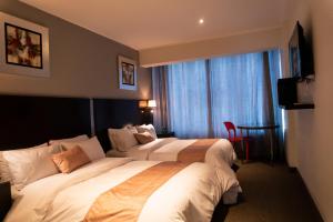 Postel nebo postele na pokoji v ubytování Apart Hotel Petit Palace Suites