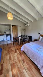 a bedroom with a bed and a table with chairs at Cabaña monoambiente en Bariloche 3 pax in San Carlos de Bariloche