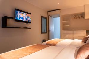 Postel nebo postele na pokoji v ubytování Apart Hotel Petit Palace Suites