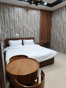 a bedroom with a large bed with a wooden headboard at Agyatvaas in Bhīm Tāl