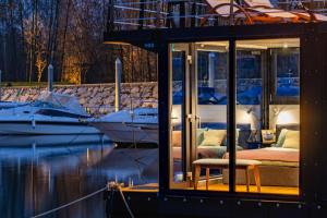 多尔梅莱托HouseBoat - Lago Maggiore con Jacuzzi的水中带一张床和一条船的房间