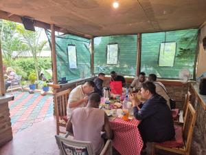 a group of people sitting at a table in a restaurant at Seven Seven B&B in Arusha